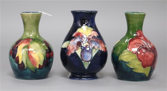 Three Moorcroft small vases in leaf and berry, hibiscus and orchid patterns tallest 9cm